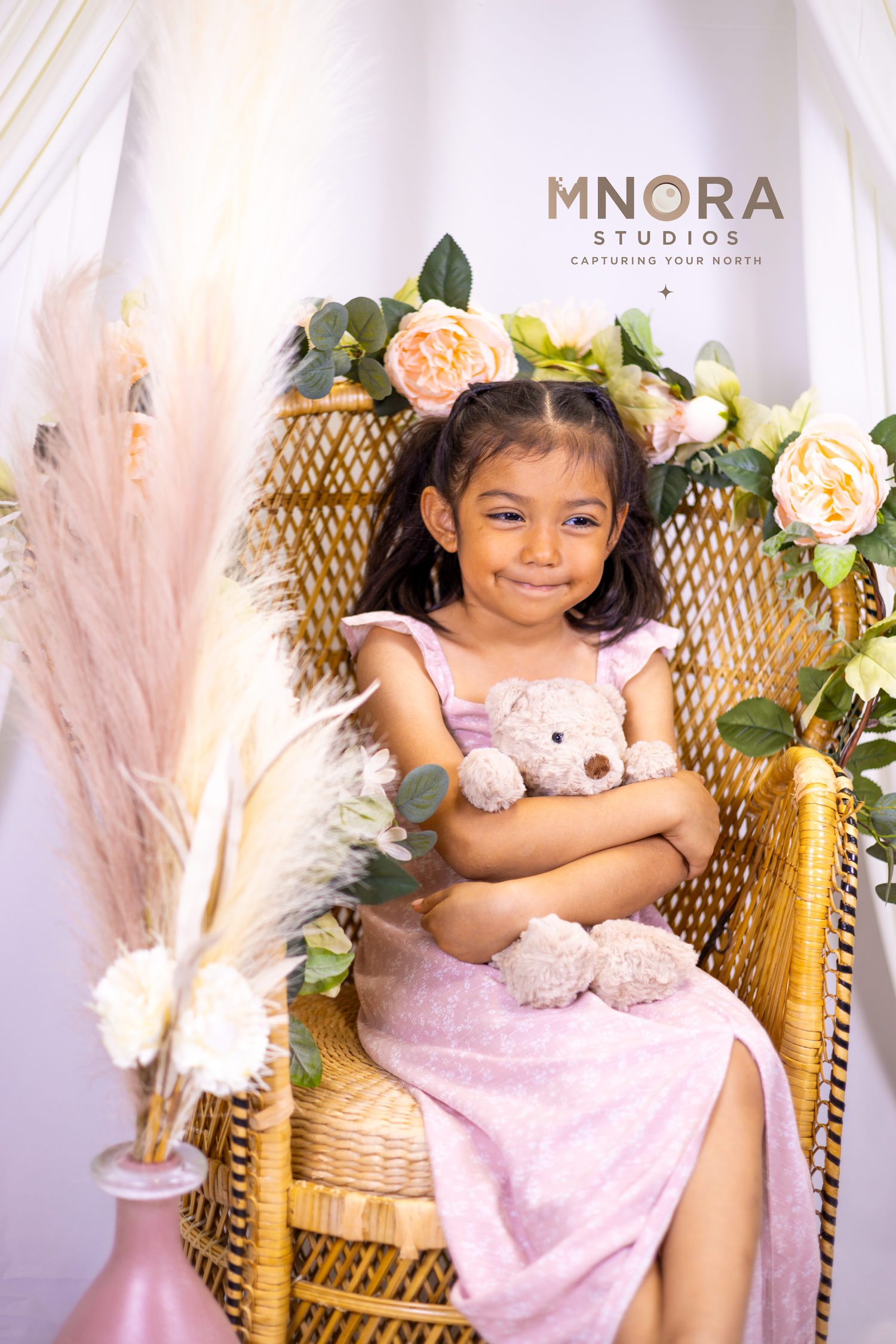 Young girl in pink dress during studio portrait session at MNORA Studios