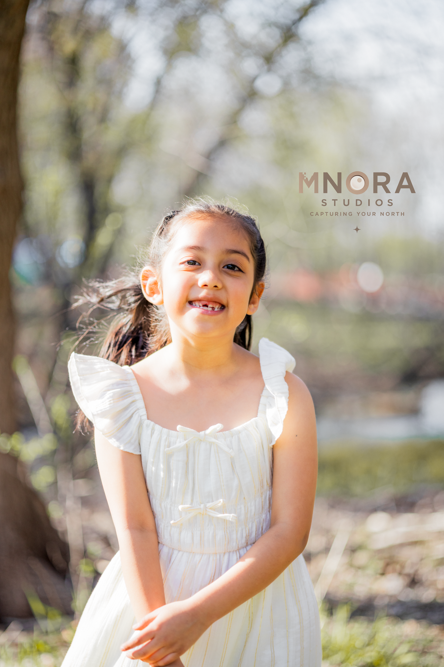 Outdoor spring portrait of girl in white dress at Minneapolis park