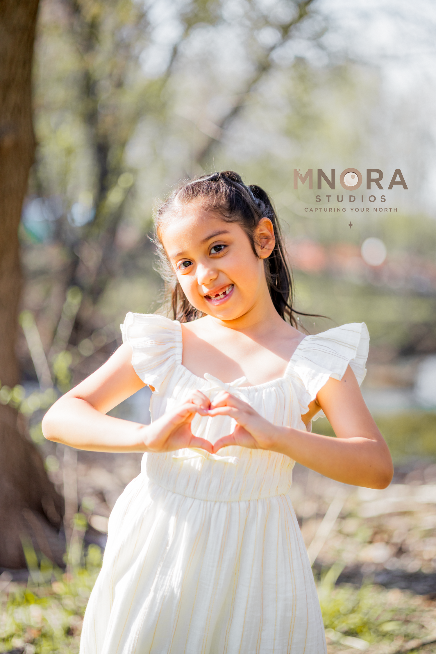 Girl in white dress twirling during outdoor portrait session in Minneapolis