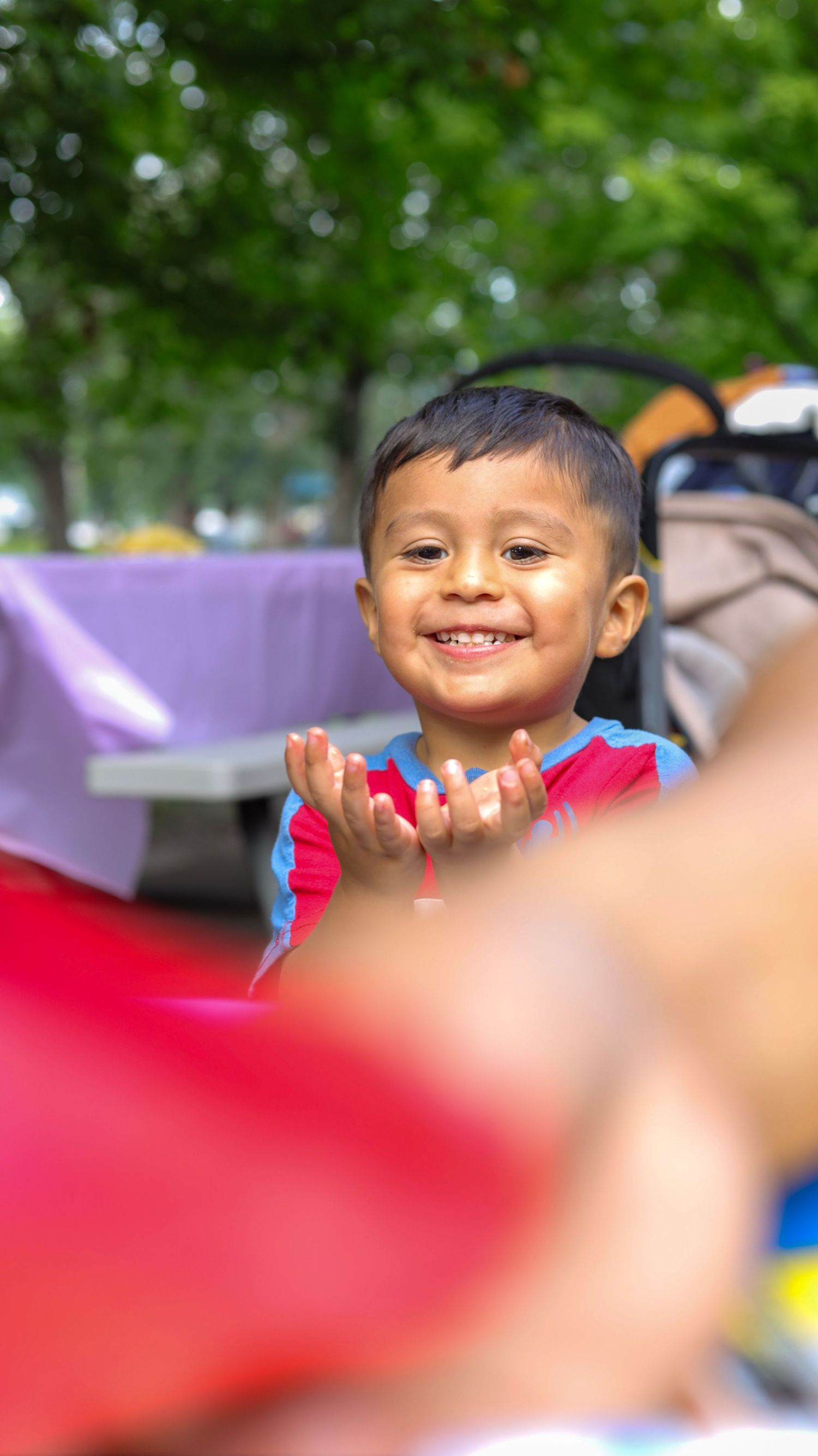 Toddler excited to receive a new birthday gift.