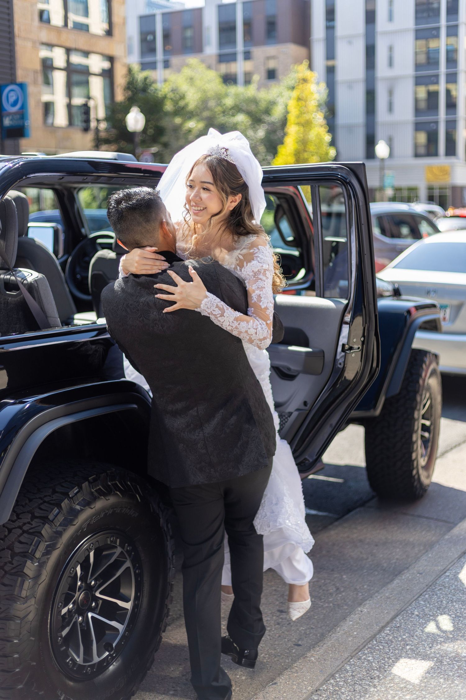 Bride and groom sharing moment beside vintage car after Minneapolis wedding