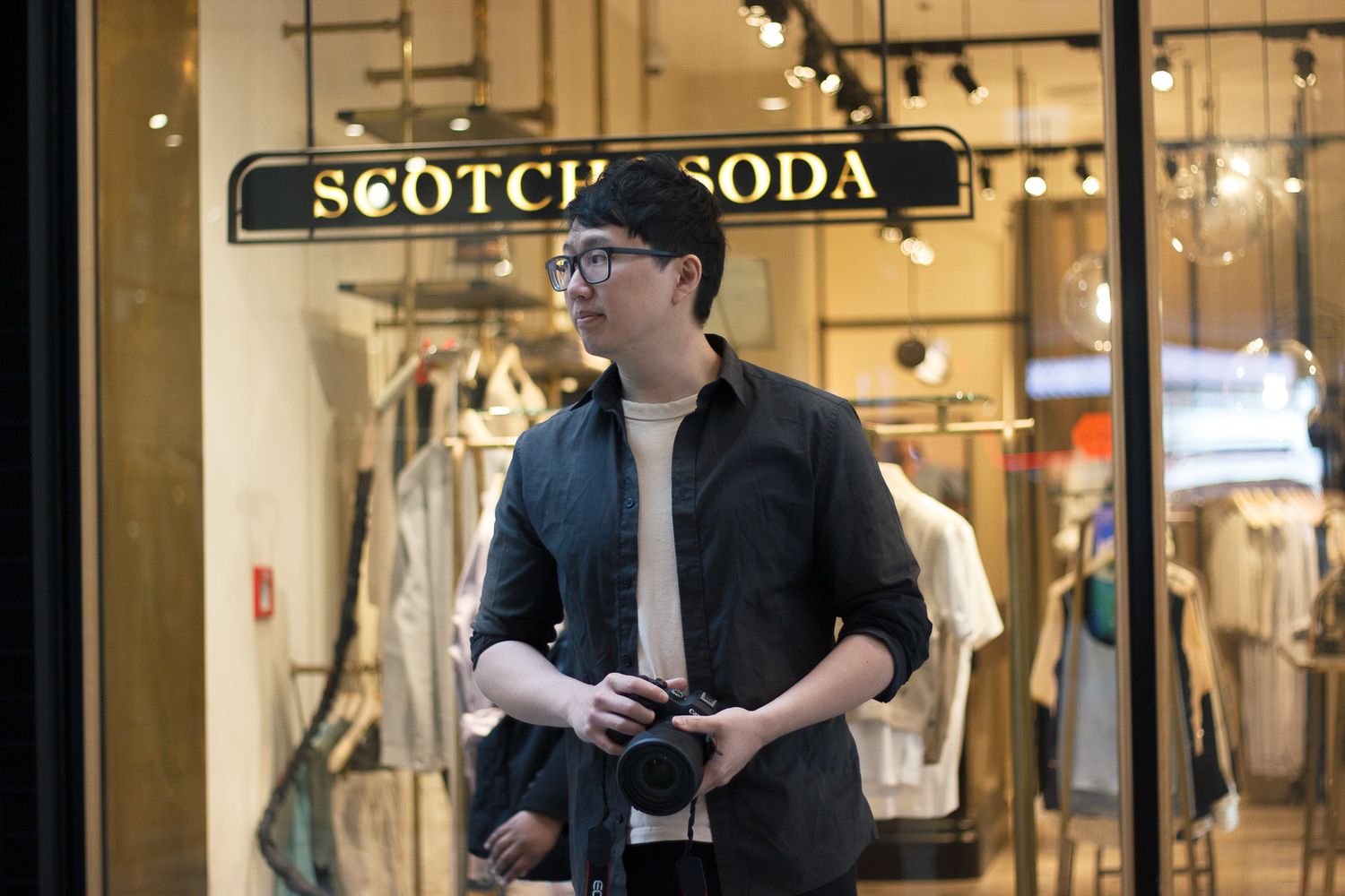 David, owner of DFU Photos, holding a camera during a photography session.