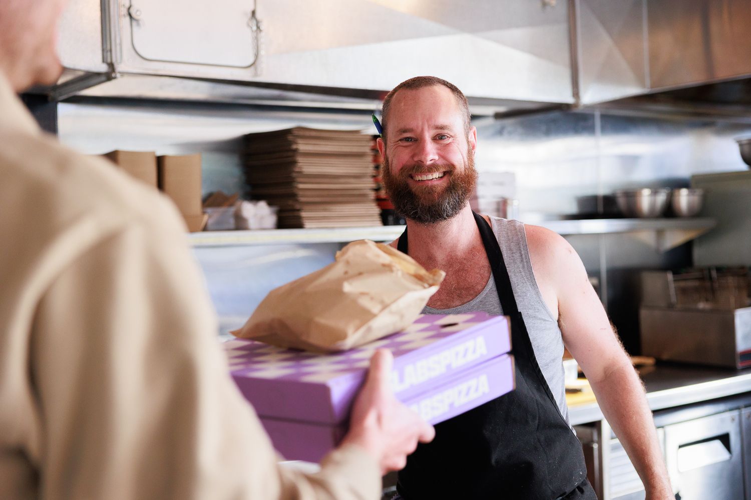 Business owner of SLABS Pizza, Onehunga, Auckland giving pizza during a personal branding session