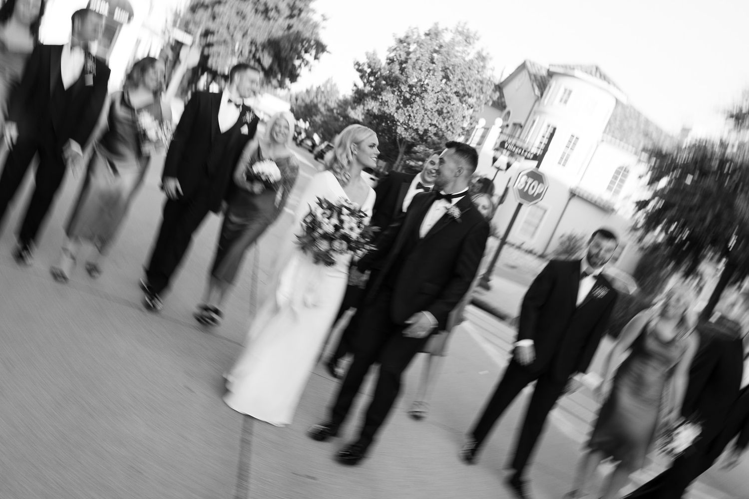 Virginia Beach and Richmond Wedding Photographer captures Black and white photo of wedding guests walking in formal attire.