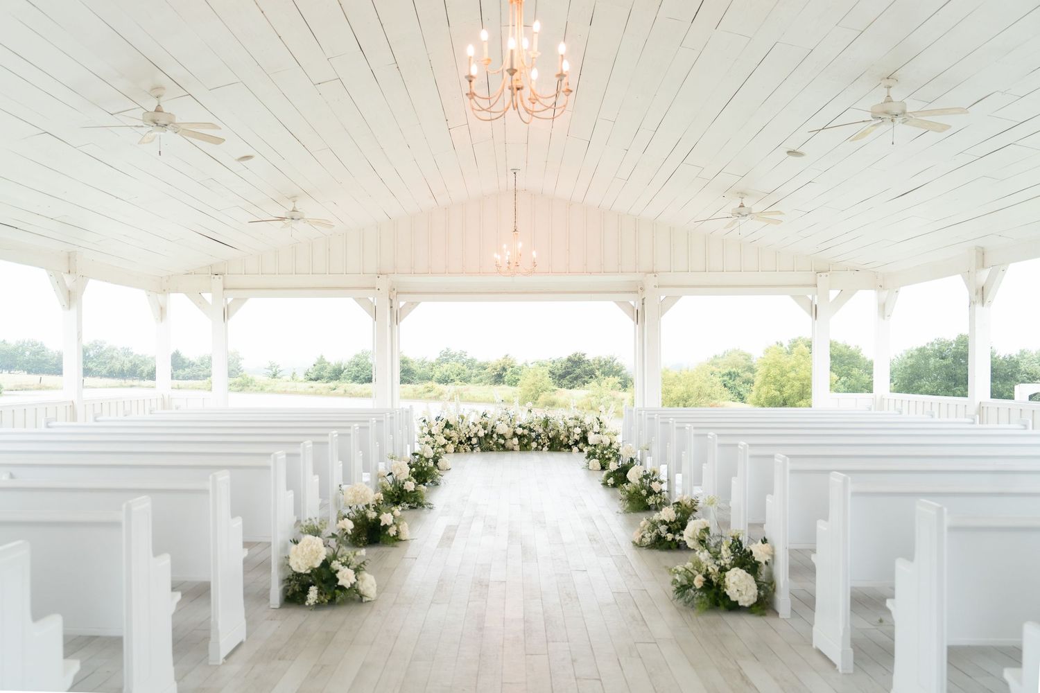 Virginia Beach and Richmond wedding photographer captures white wedding chapel interior at The Grand Ivory in Leonard Texas.