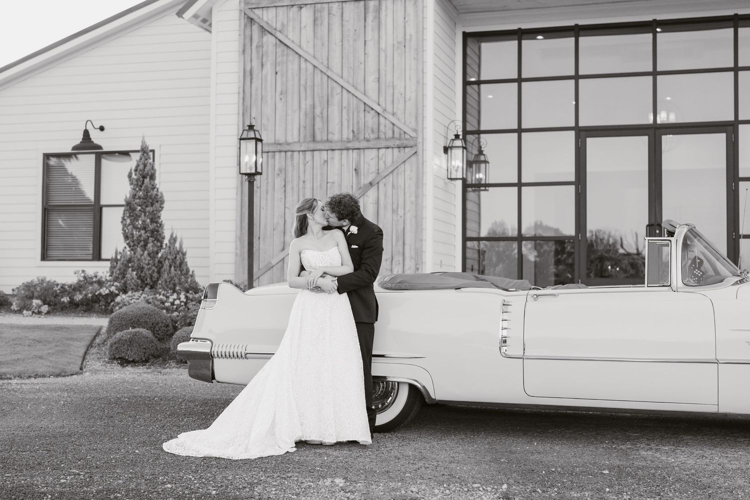 A black and white wedding photo series showing a bride in a flowing white dress walking through various outdoor settings.