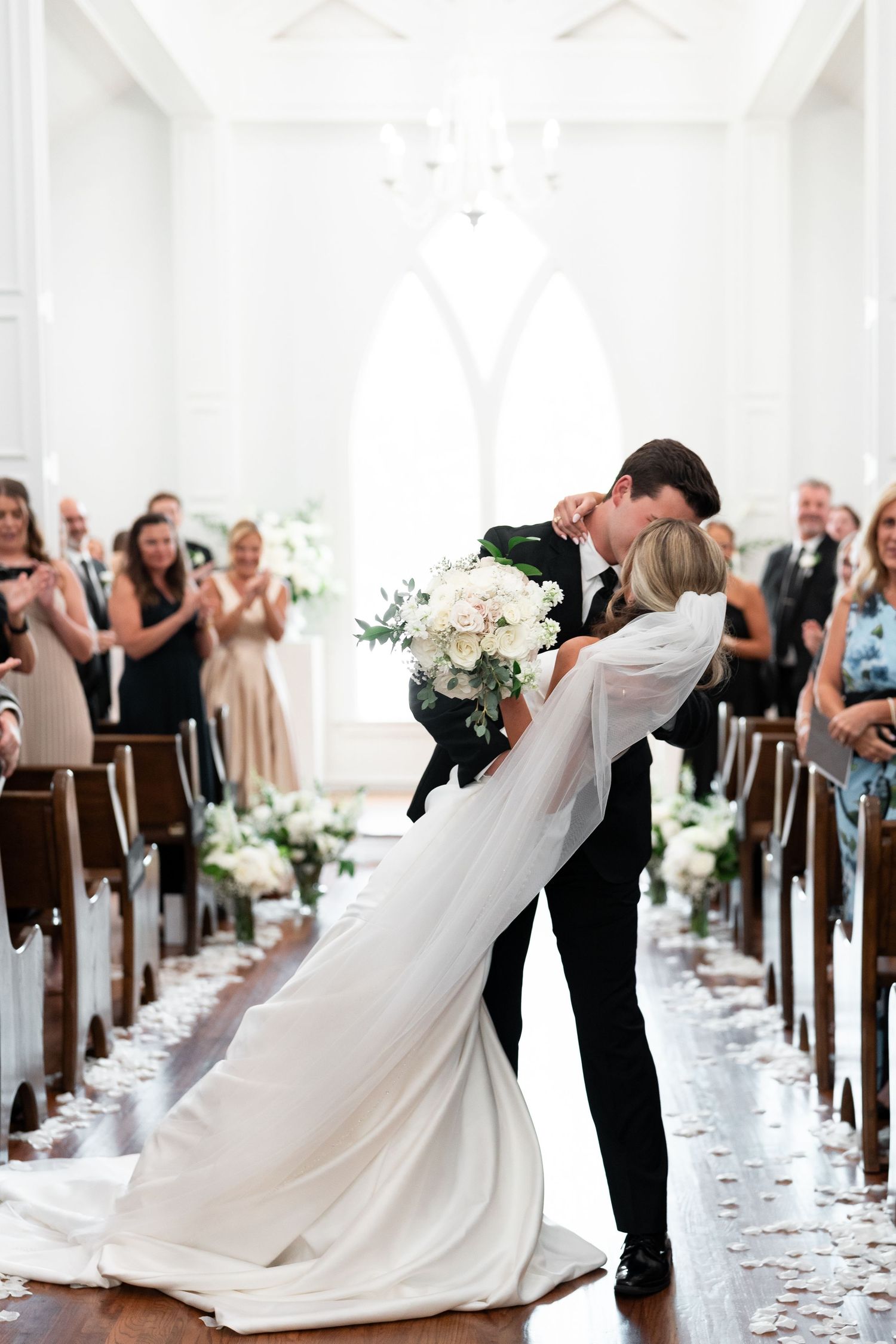 Virginia Beach and Richmond Wedding Photographer captures chapel ceremony exit kiss with white petal toss at The Springs at Valley View