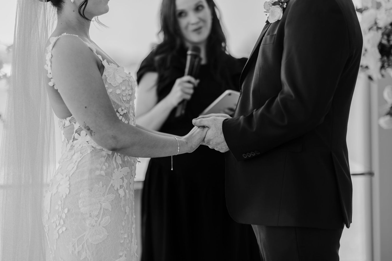 A couple shares a romantic dance at their wedding reception while guests look on with champagne glasses.