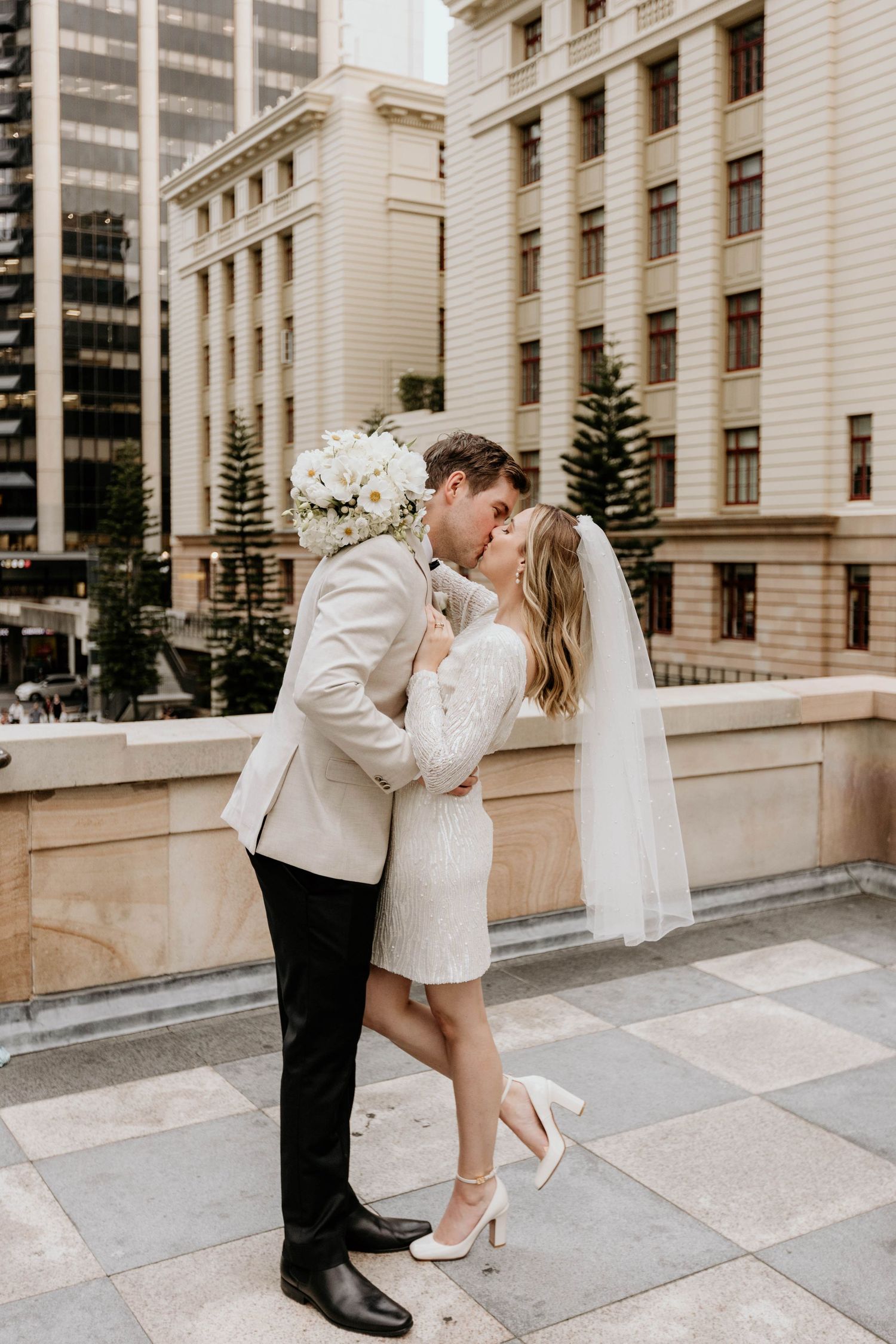 Romance captured in architectural setting as couple shares intimate moment on stone steps.