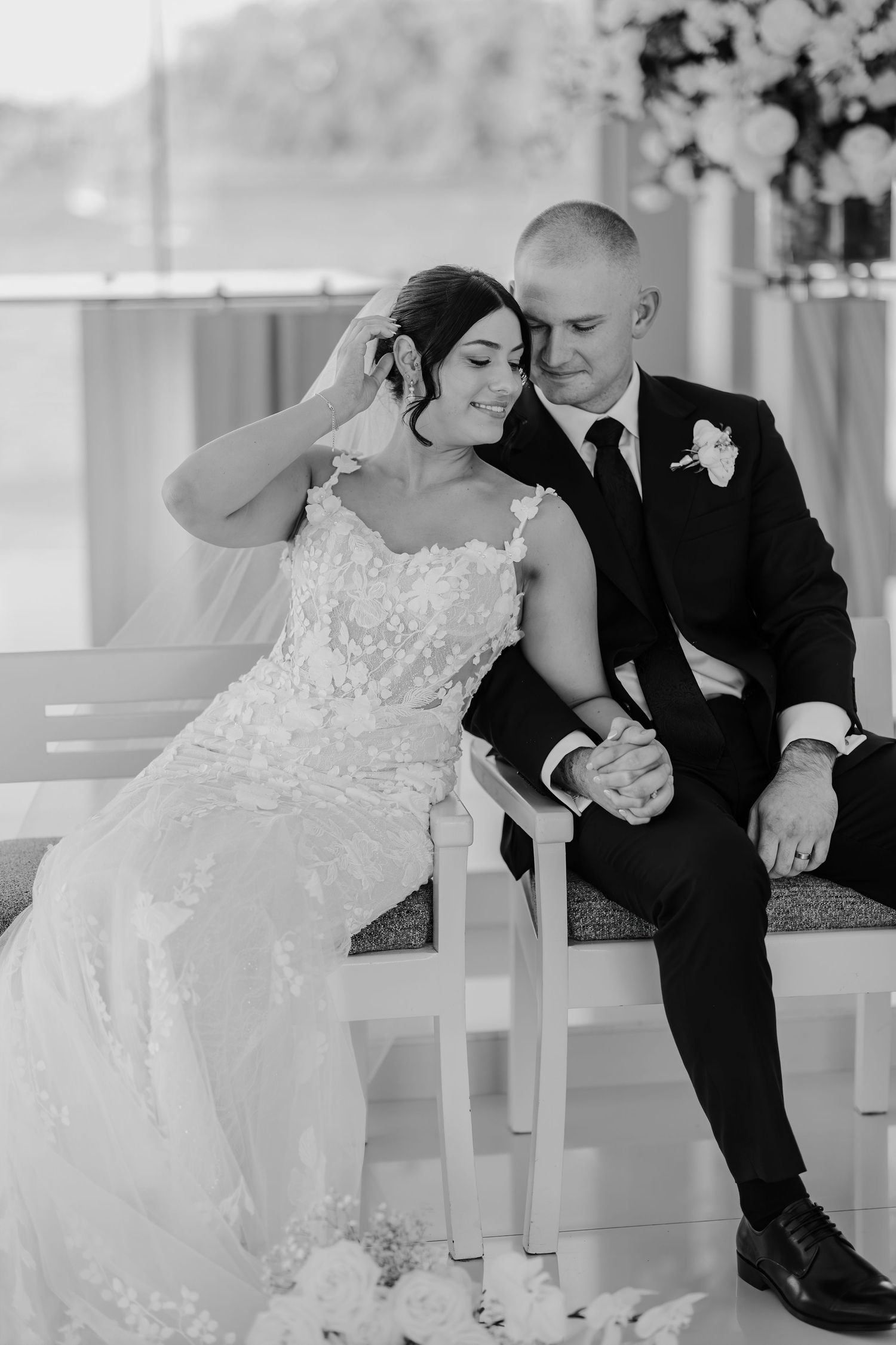A romantic black and white wedding photo series showing tender moments between a couple in formal attire.