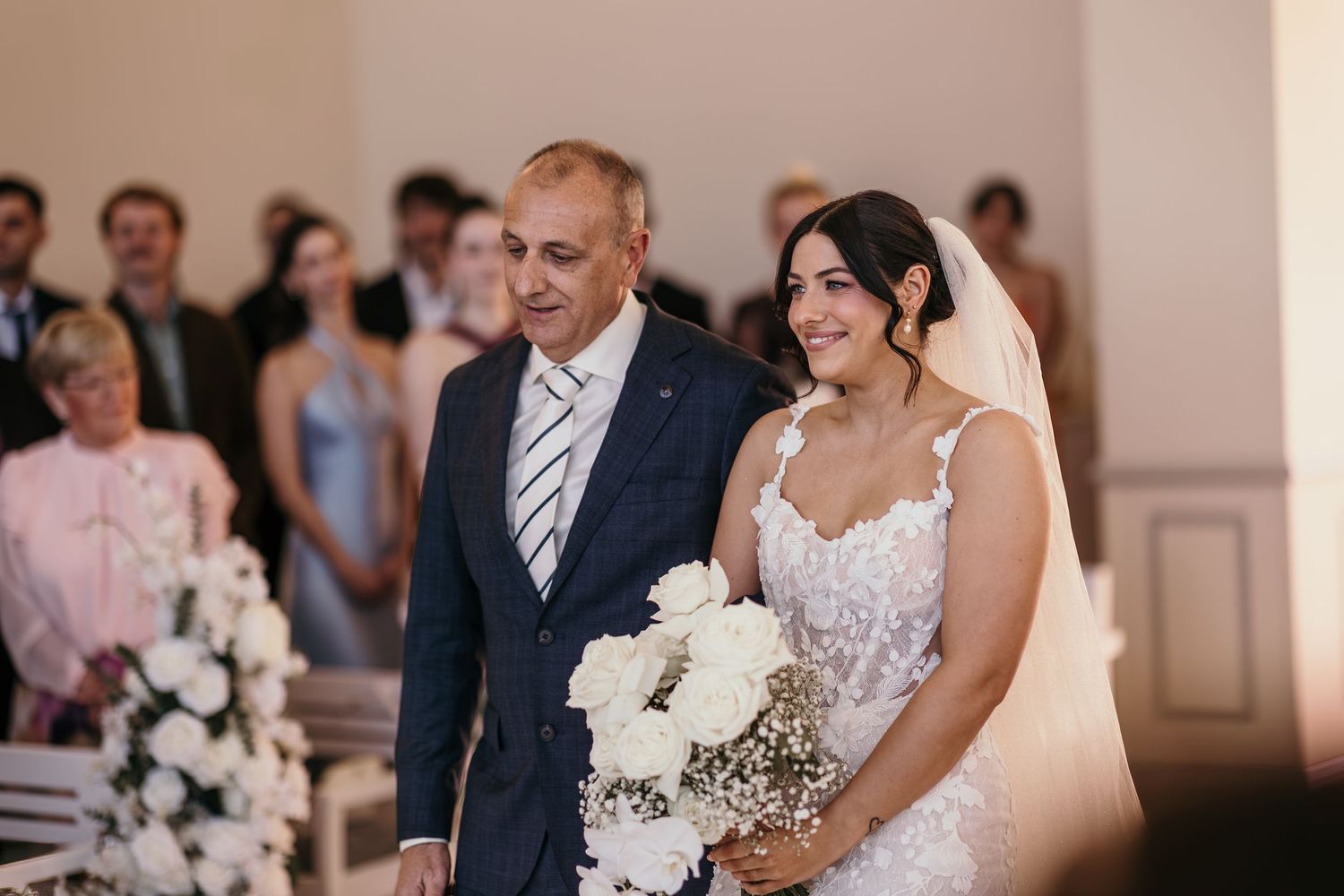A wedding ceremony montage showing joyful moments with white floral bouquets and formal attire in an elegant indoor setting.