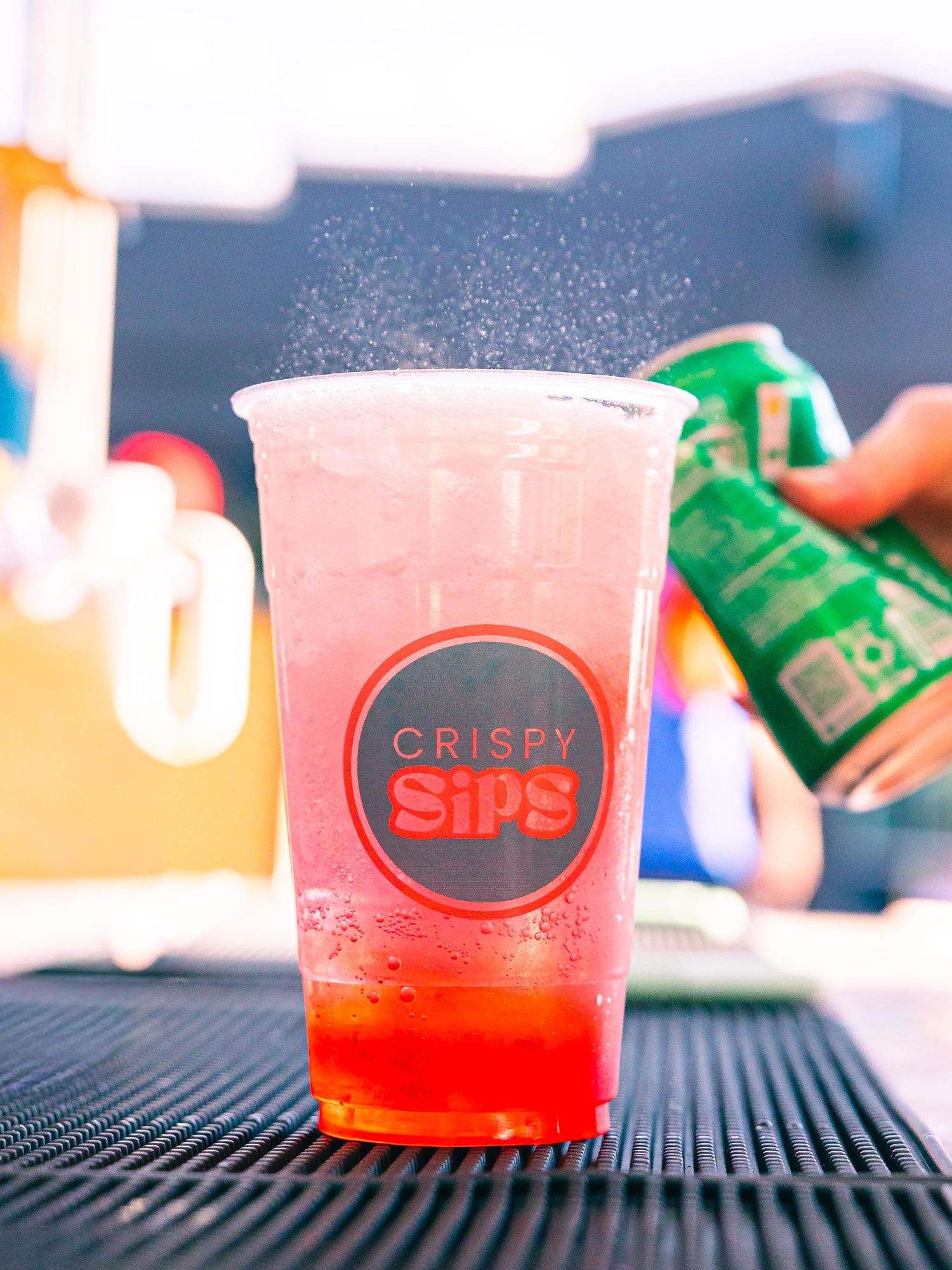 Vibrant red soda in branded cups for Crispy Sips in St. Louis.