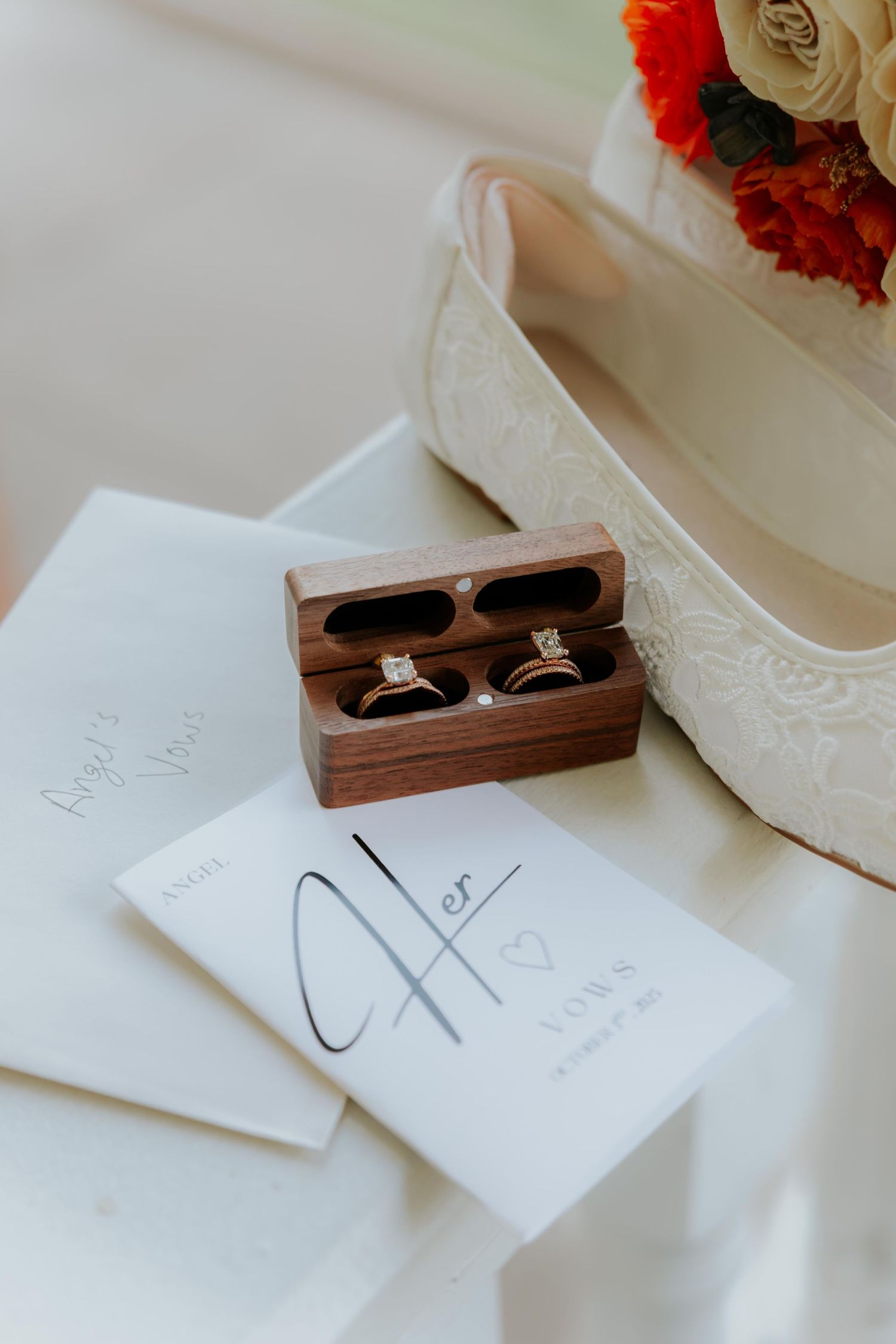 Wedding rings displayed in a wooden box with handwritten notes.