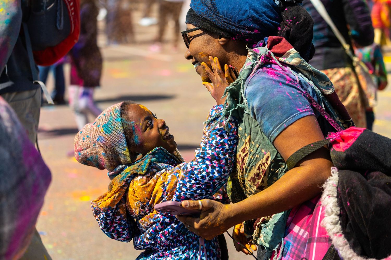 A joyful moment captured during a colorful festival/event  celebration outdoors.