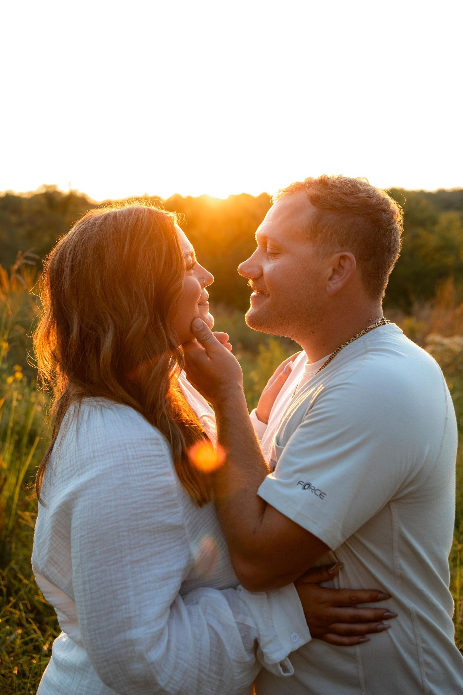 Romantic couple photos at sunset with warm golden lighting in a natural outdoor setting at Queeny Park near St. Louis.
