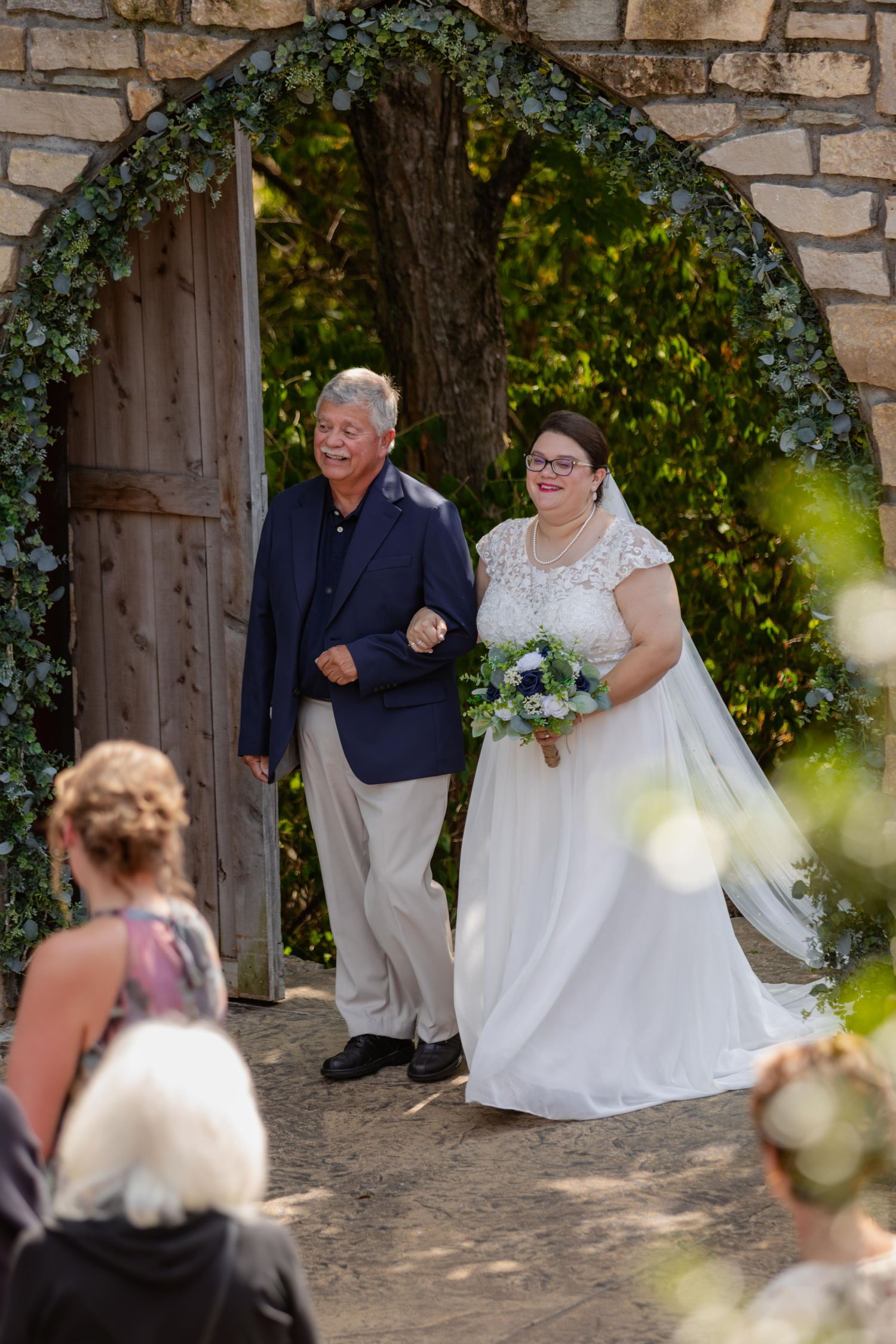 Bride walking down the aisle with her father at her wedding in St. Charles, Missouri.