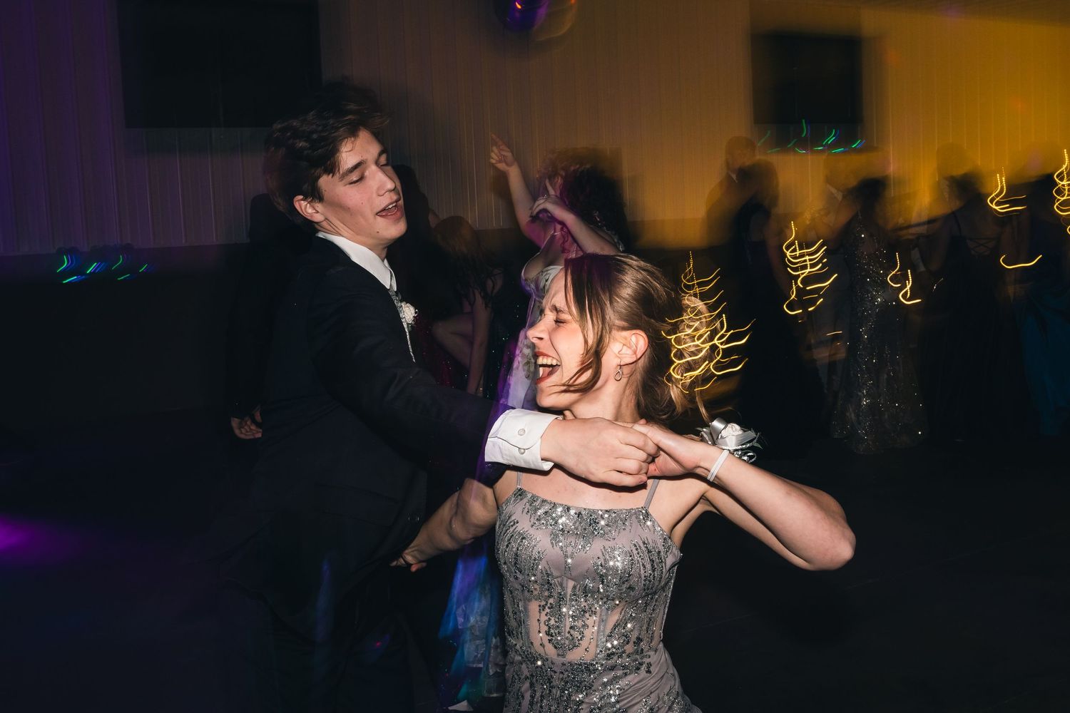 Dimly lit dance floor scene with party event lighting and celebration atmosphere.