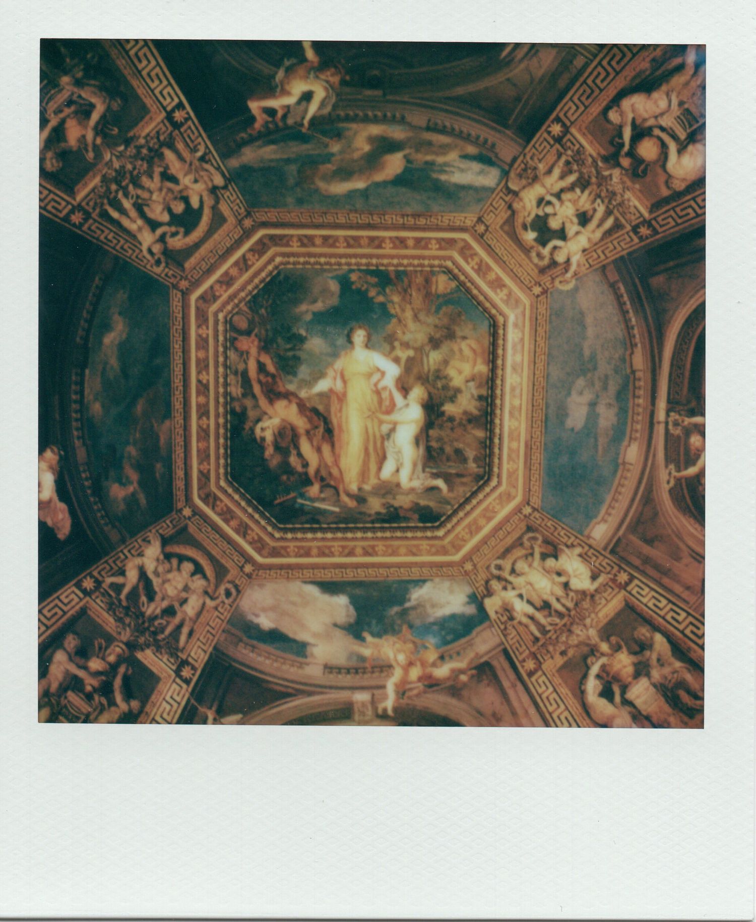 Ornate painted ceiling of the Vatican Museums featuring classical mythological scenes in an octagonal frame.