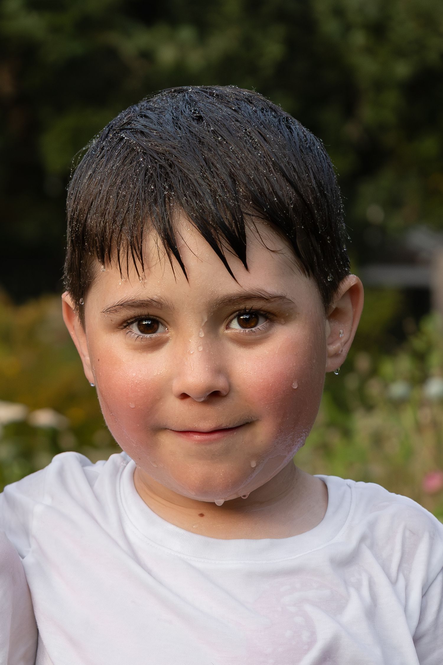 A portrait of a young boy smiling and looking at the camera.