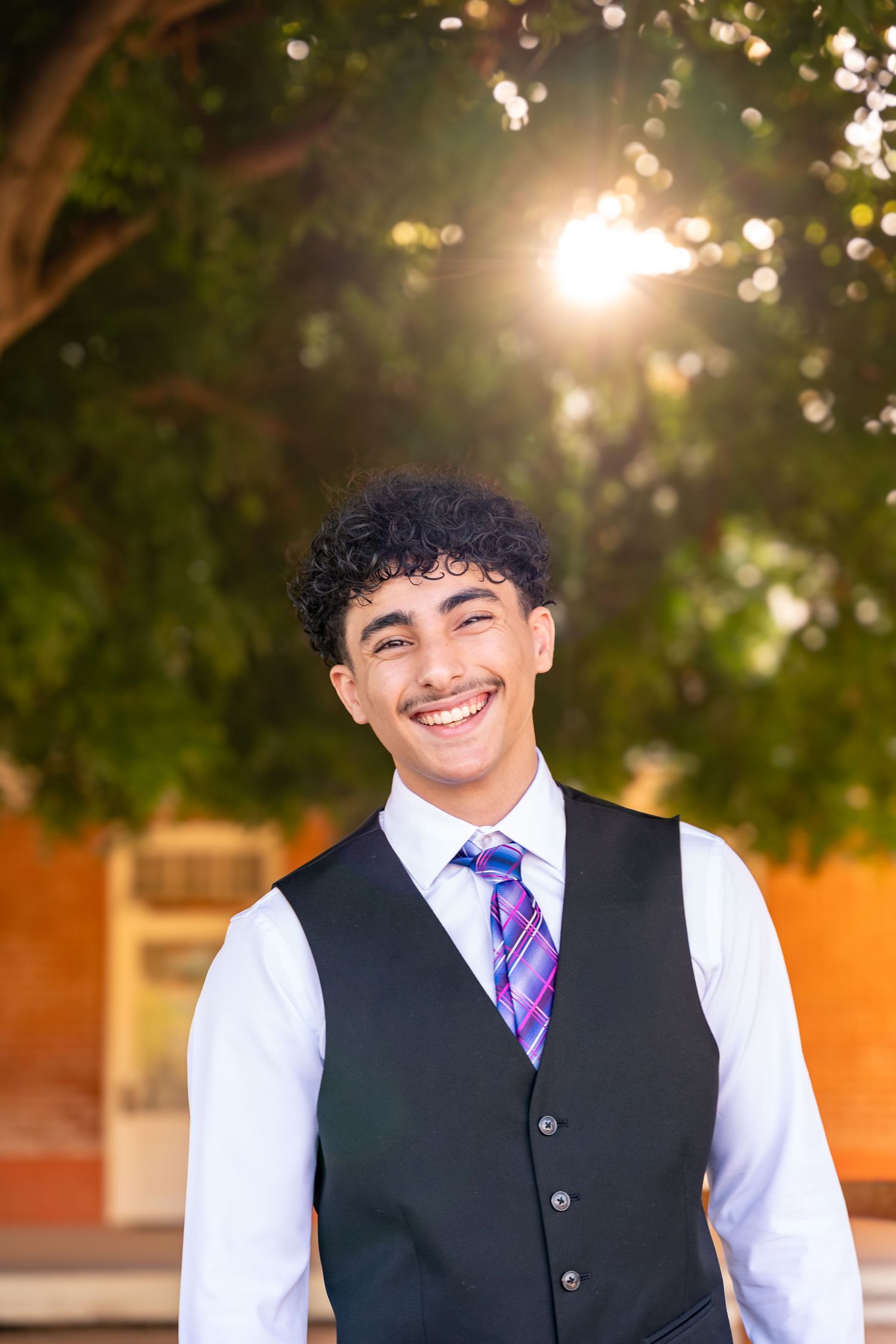 boy poses with a massive smile