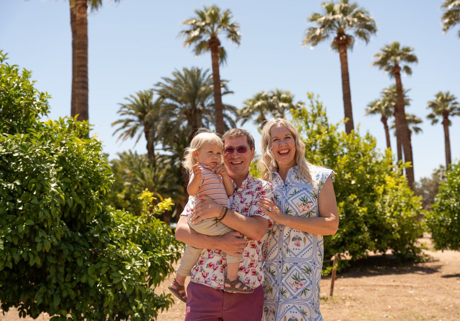 family standing outdoors laughing