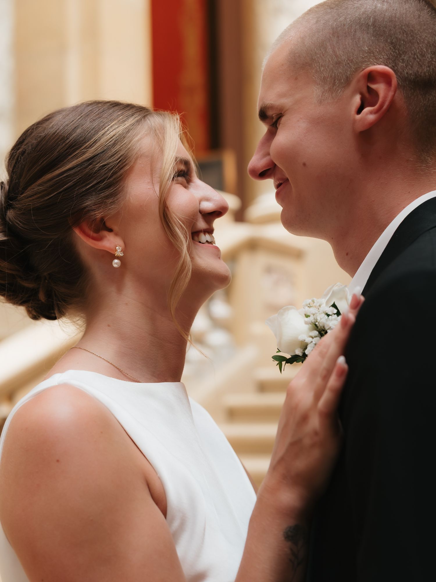 Smiling bride and groom share a joyful moment together at their wedding venue.