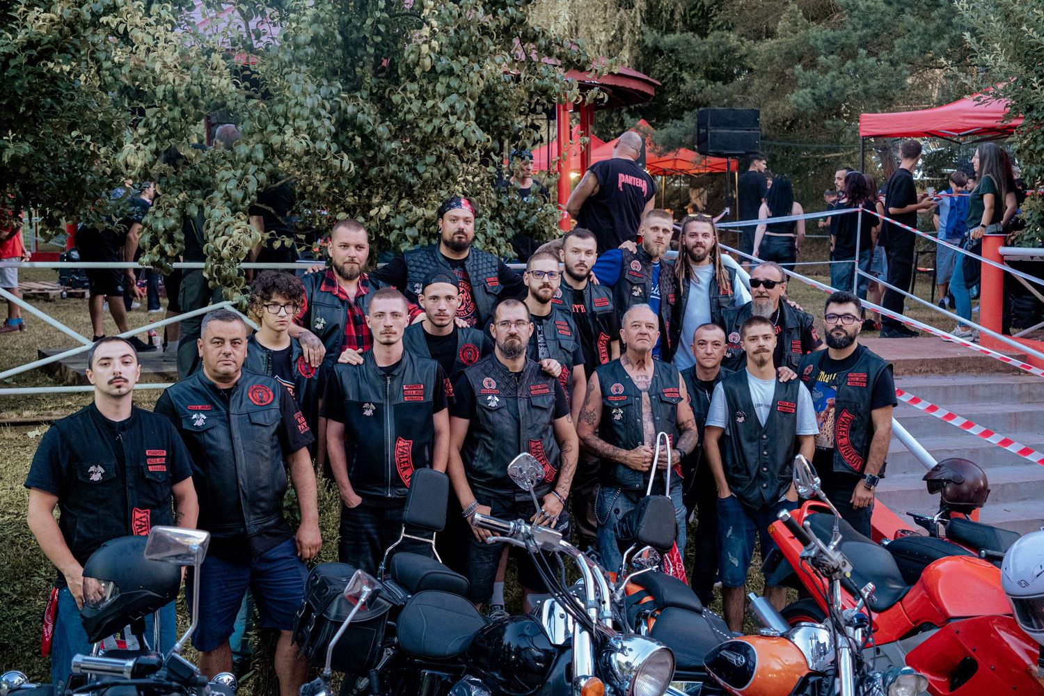 Large group of Road Patrol MC motorcycle club members posing together with bikes outdoors.