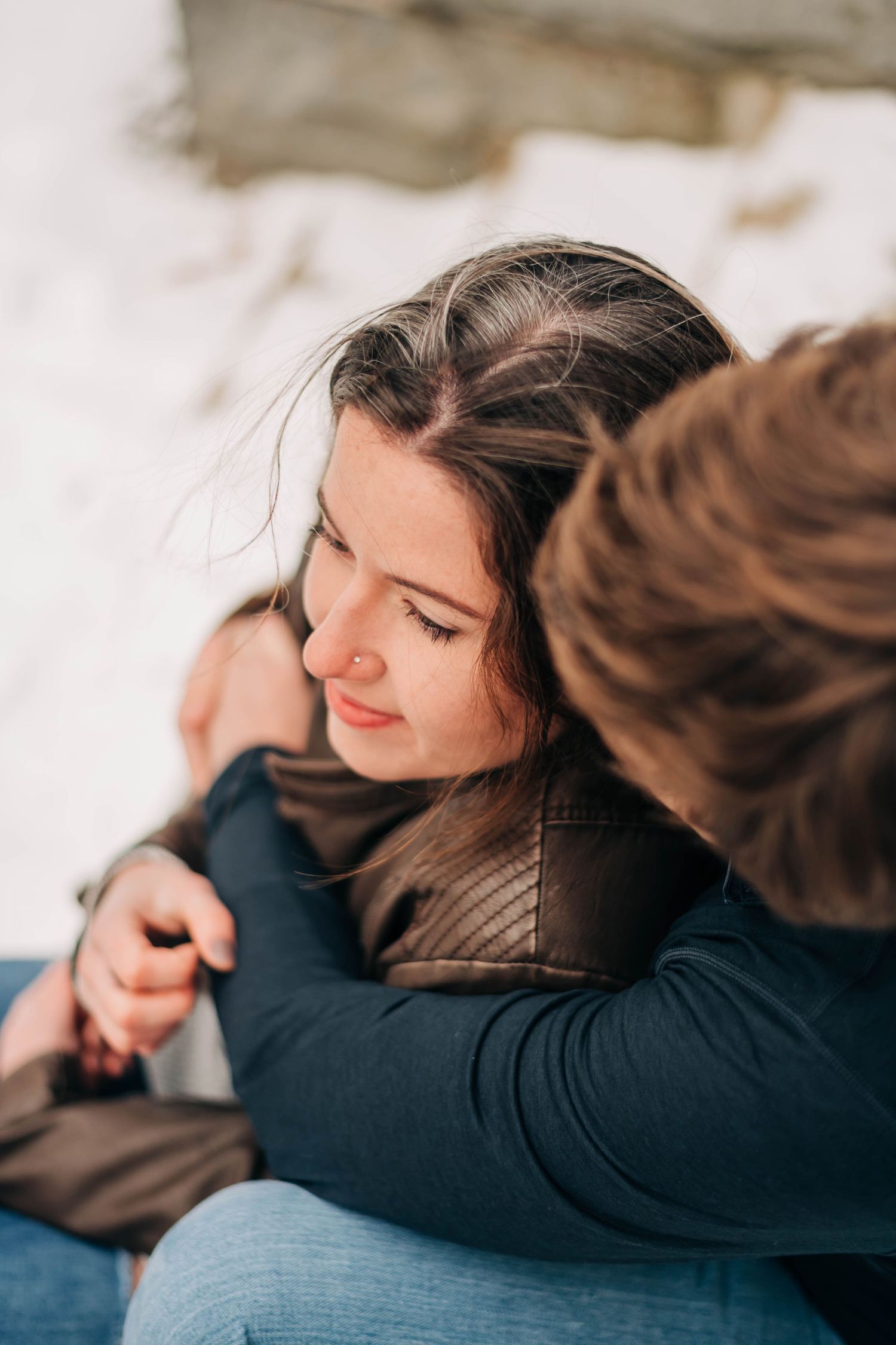 Photo from above of engaged man and woman sitting on steps