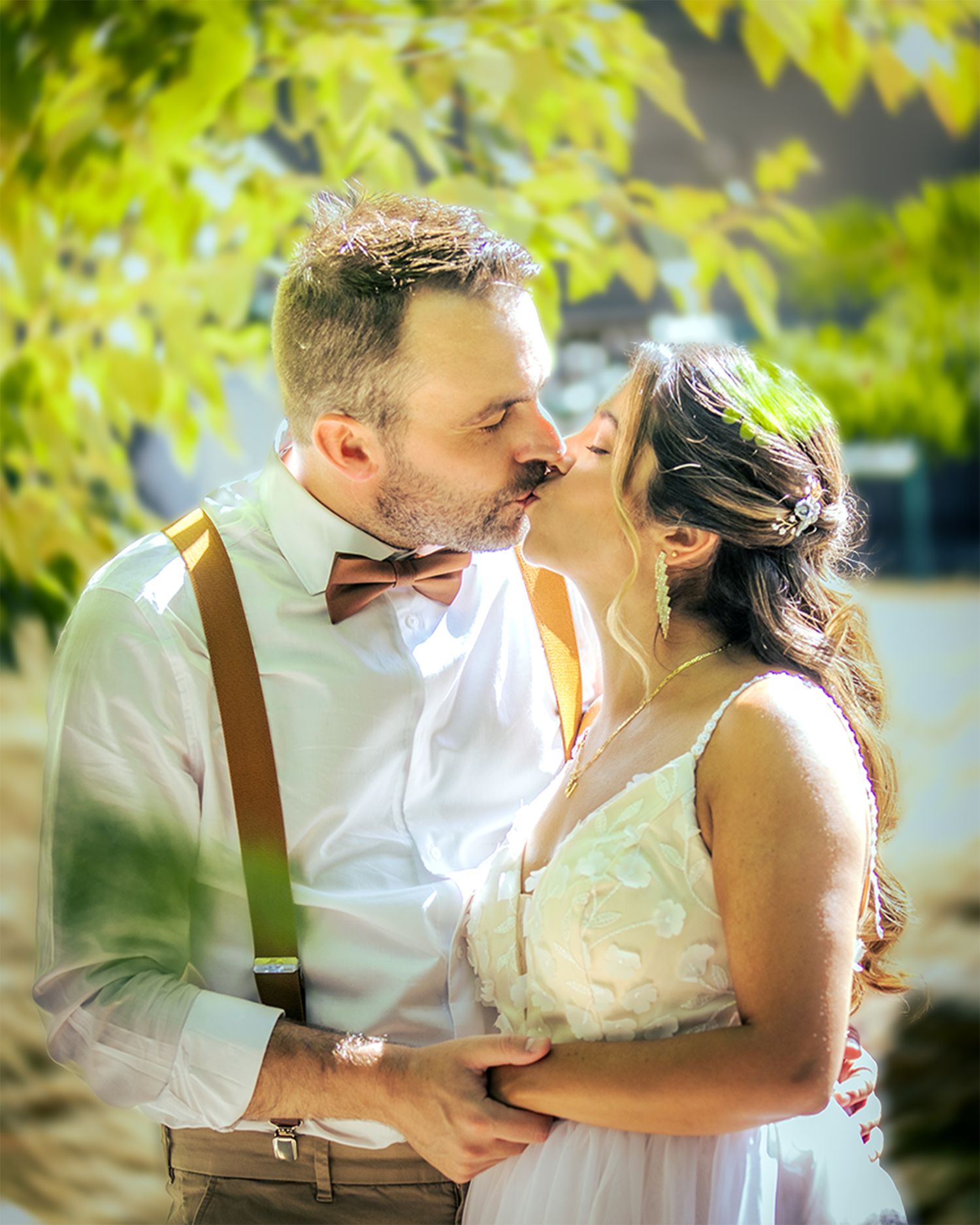 Bride and groom sharing a kiss outdoors under trees at their Vancouver wedding