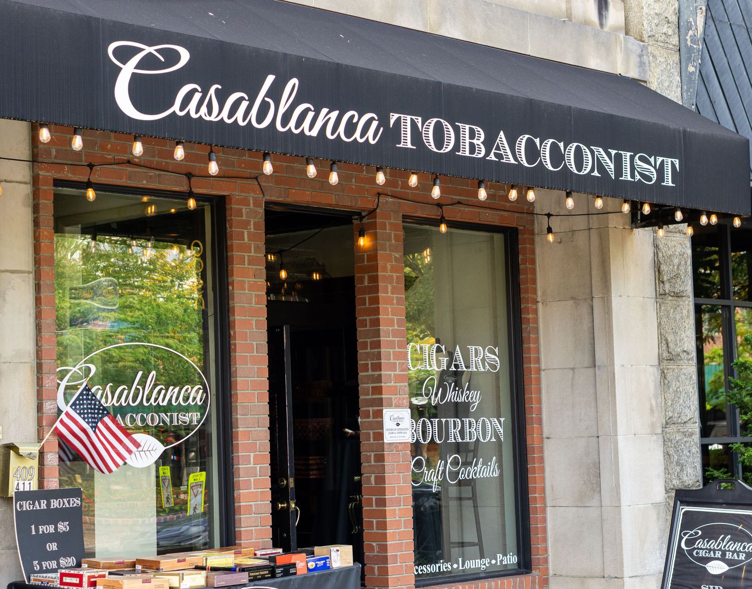 Casablanca Tobacconist shop front featuring cigars, whiskey, bourbon, and cocktails signage.