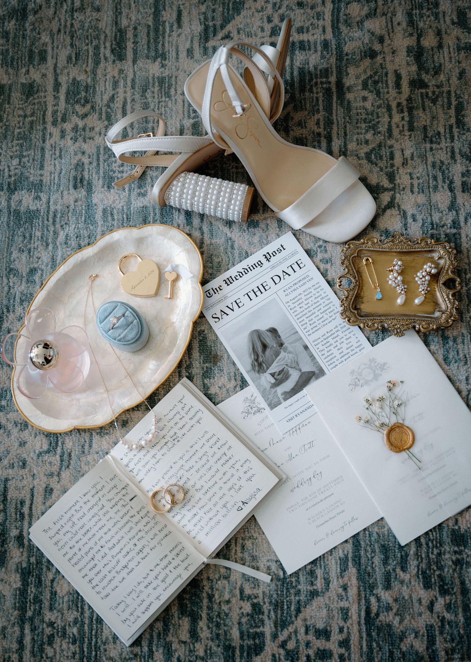 Flat lay of wedding details including shoes, save the date, jewelry, and accessories.