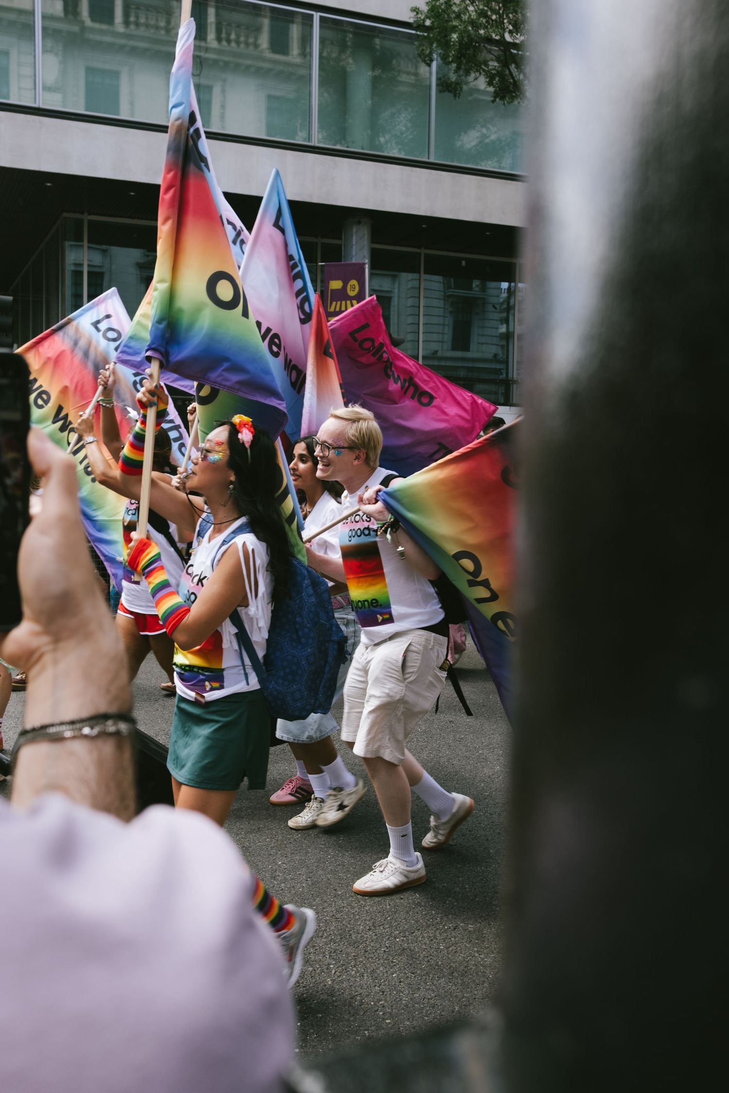 People marching with flags at the pride parade in London