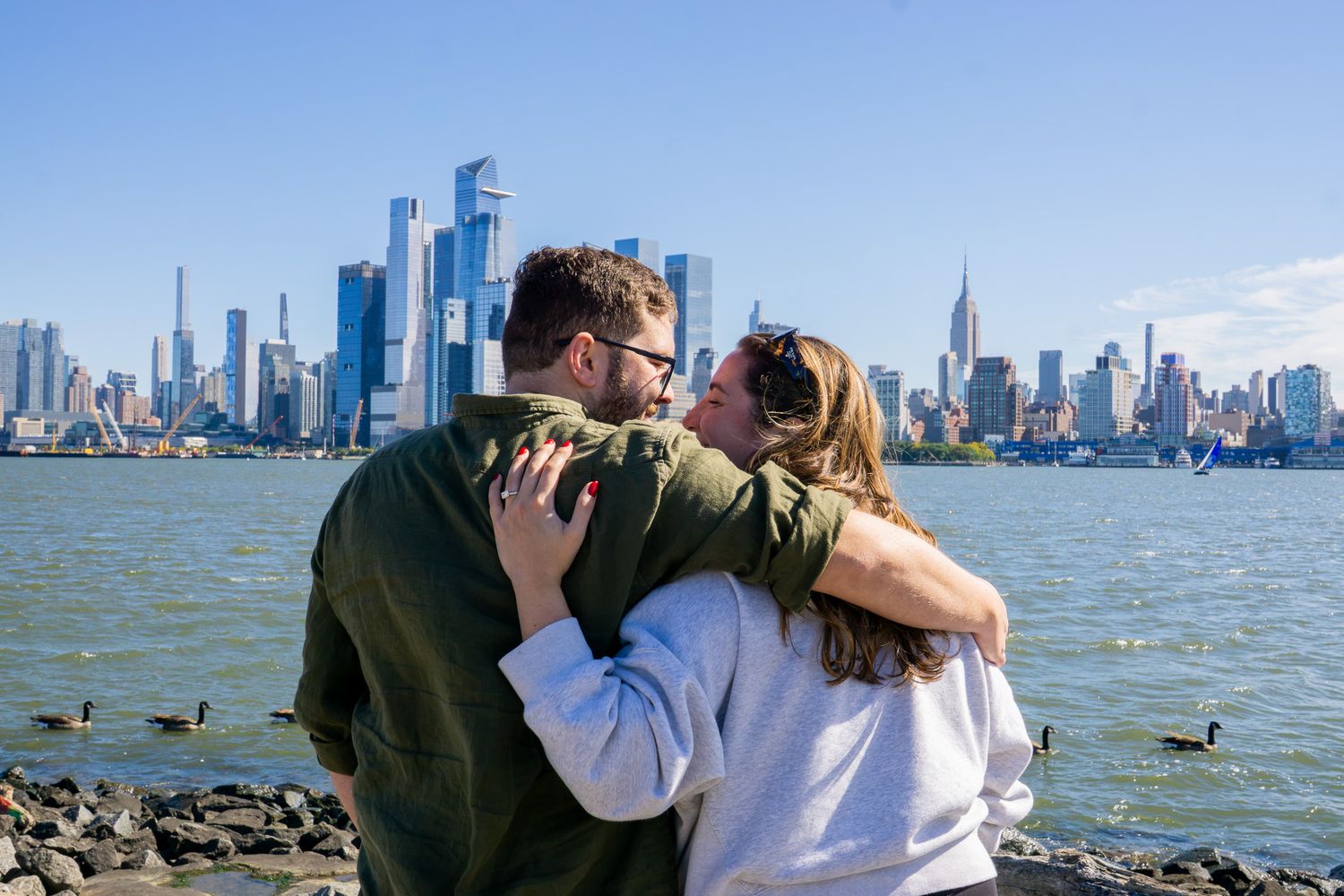 proposal with NYC skyline in the background