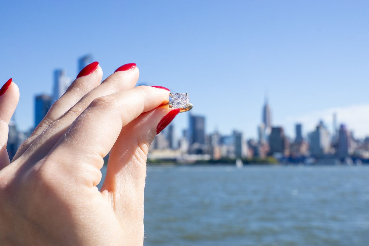 proposal with NYC skyline in the background