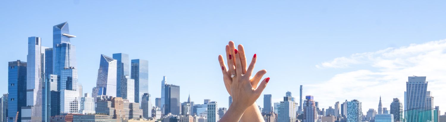 proposal with NYC skyline in the background