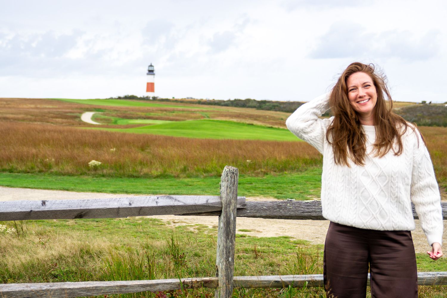 woman in front of lighthouse