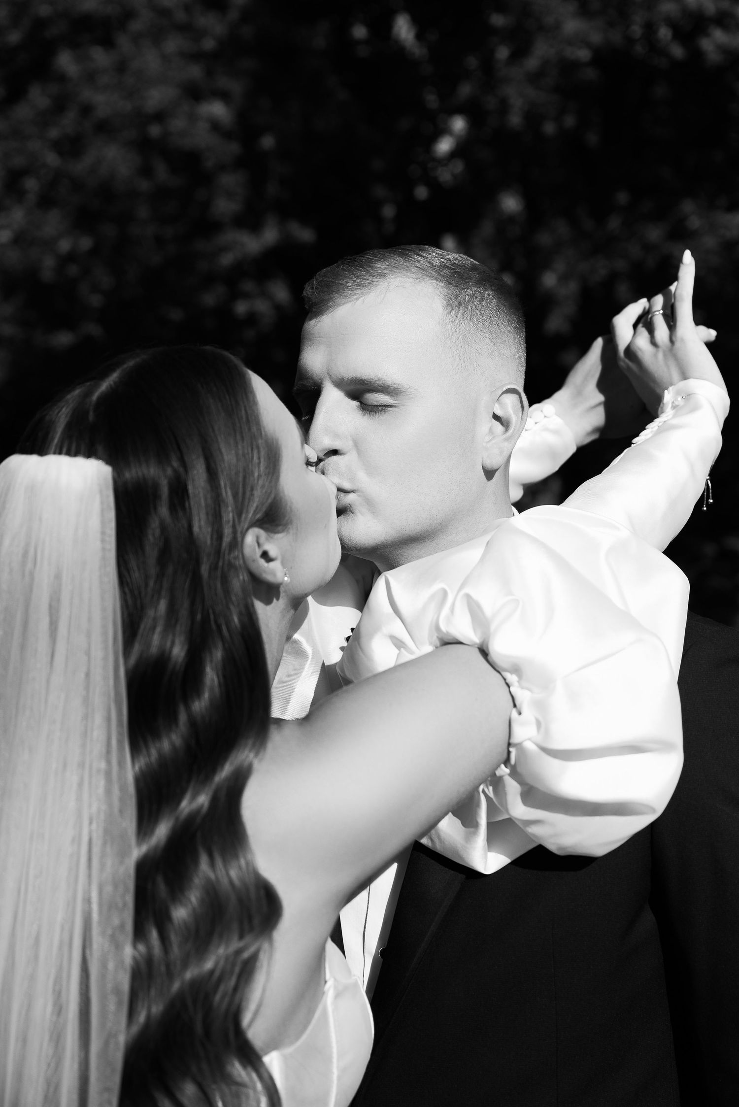 Black and white sequence of romantic wedding couple embracing and kissing.