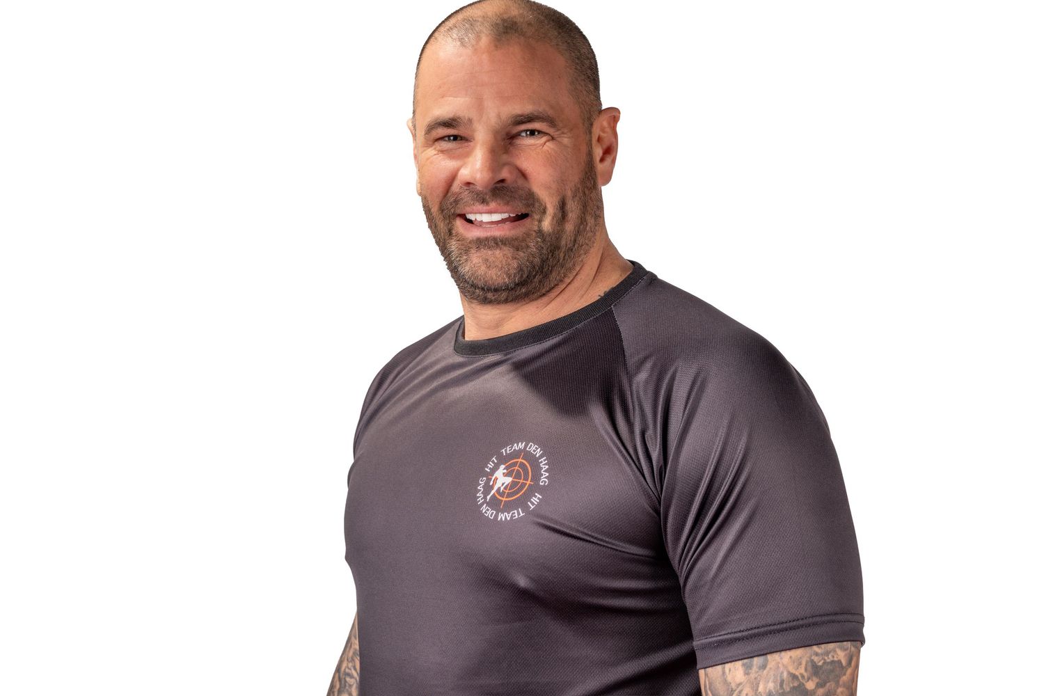 Athletic man in dark gray t-shirt showing different poses and expressions against white background.