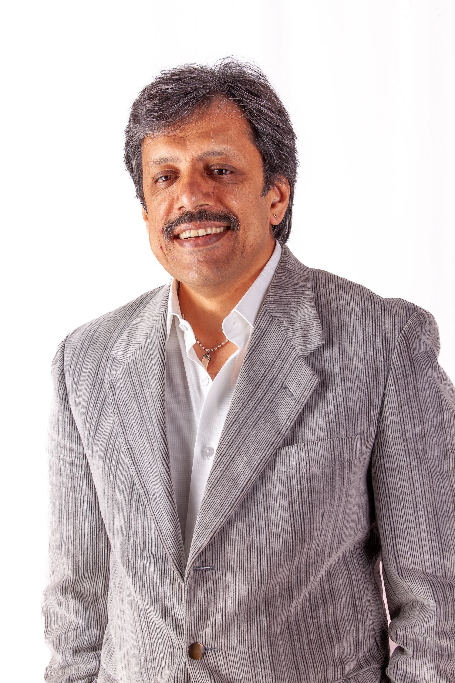 Portrait series of person in gray suit and white shirt showing various expressions.