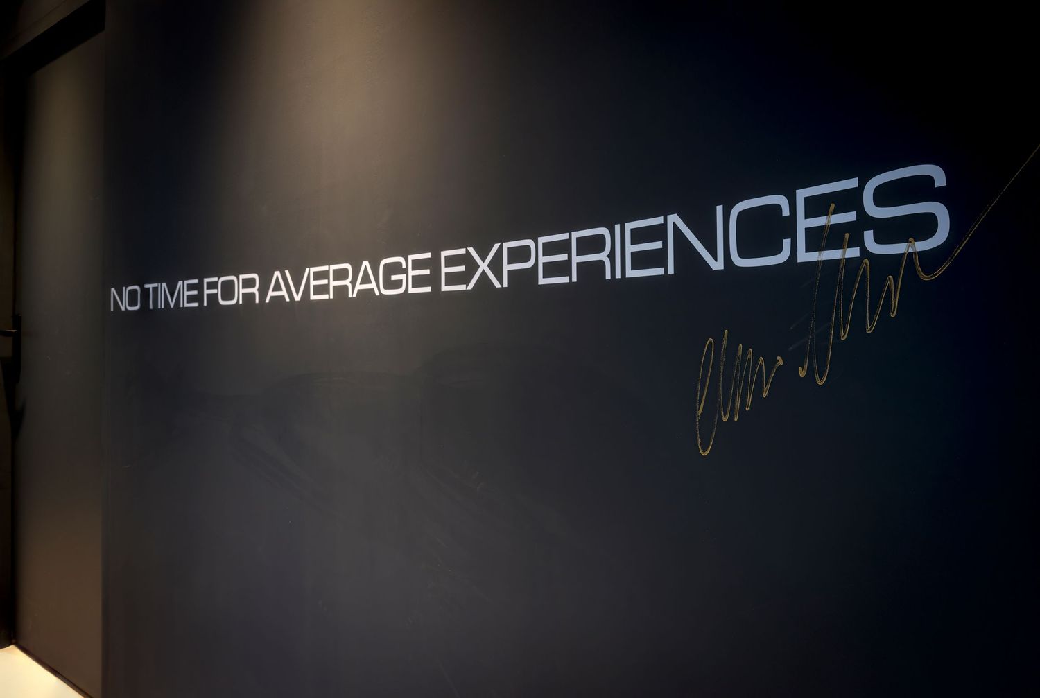 A dimly lit nightclub interior with glowing neon lights and illuminated signage displaying 'EXPERIENCE'.