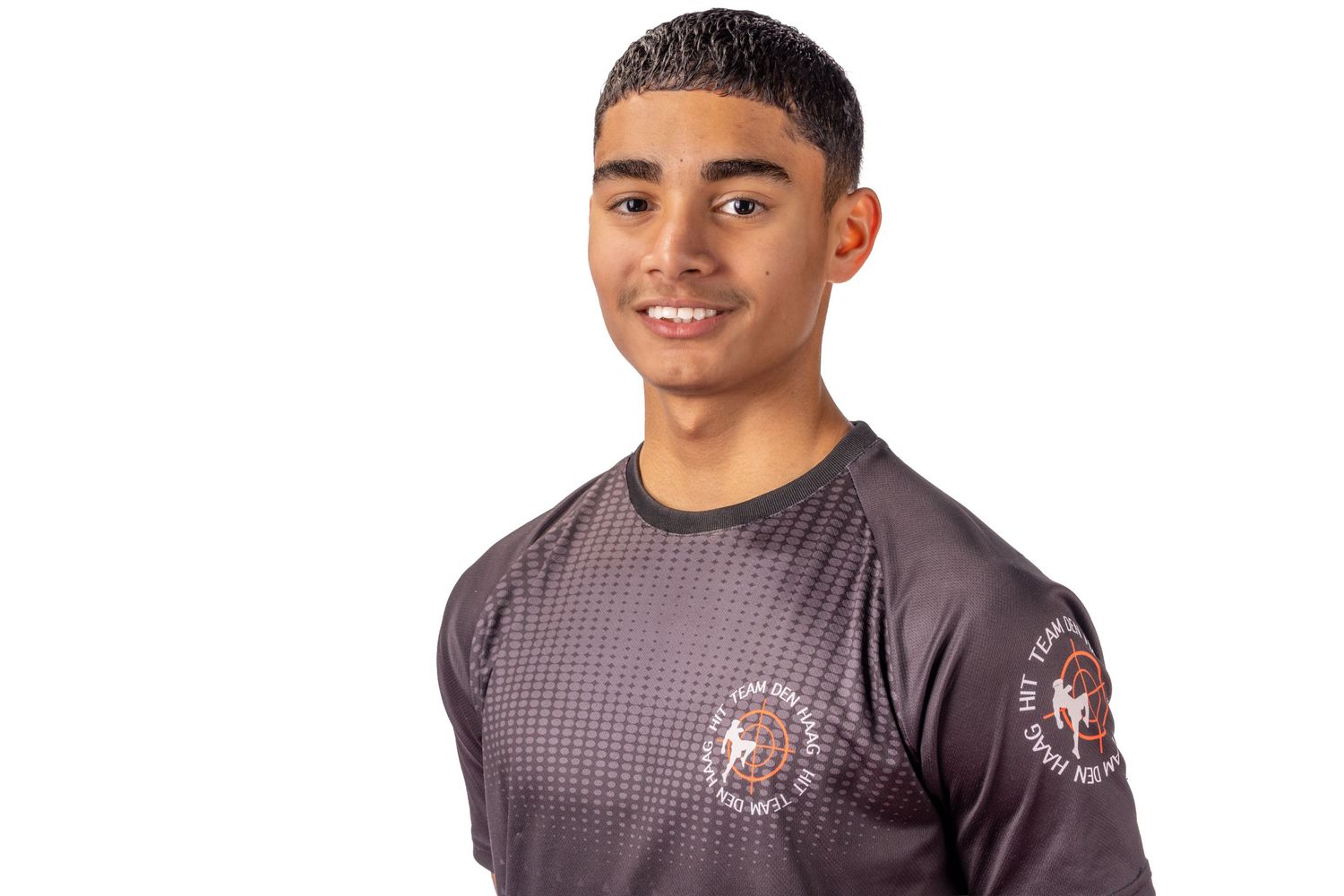 Athletic person wearing a gray checkered shirt poses against white background.