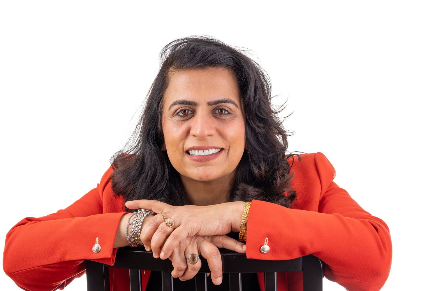 Person in bright orange jacket posing in multiple playful positions against white background.