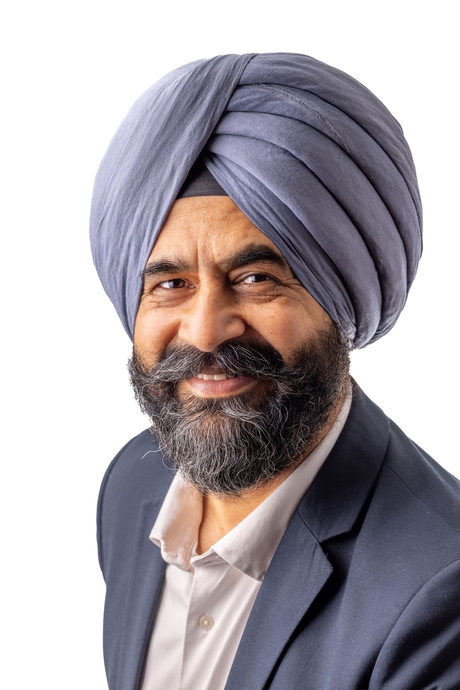 Professional headshot series of a person in a blue turban and suit jacket against white background, showing different angles.