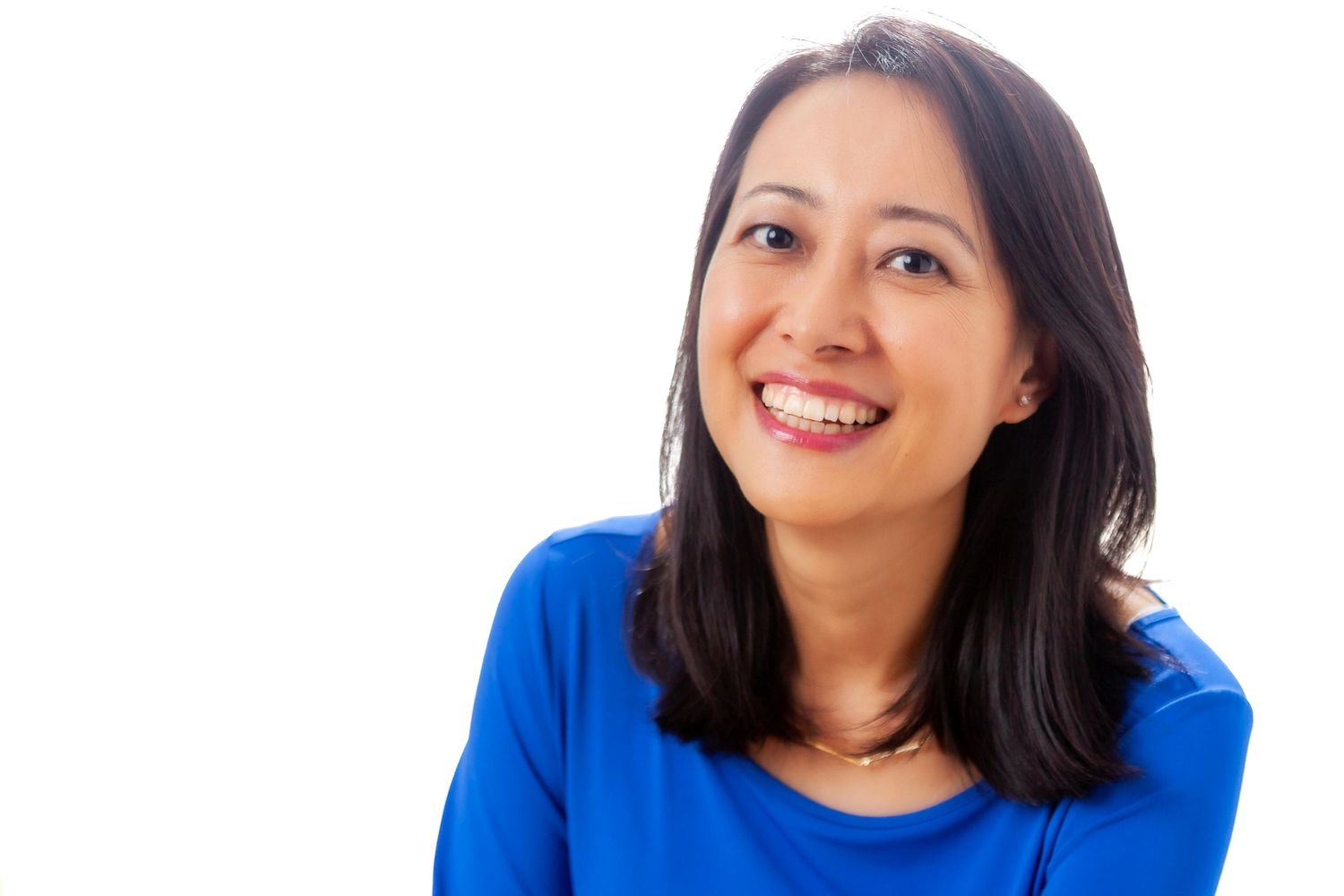 Portrait series showing person in bright blue top with different expressions.