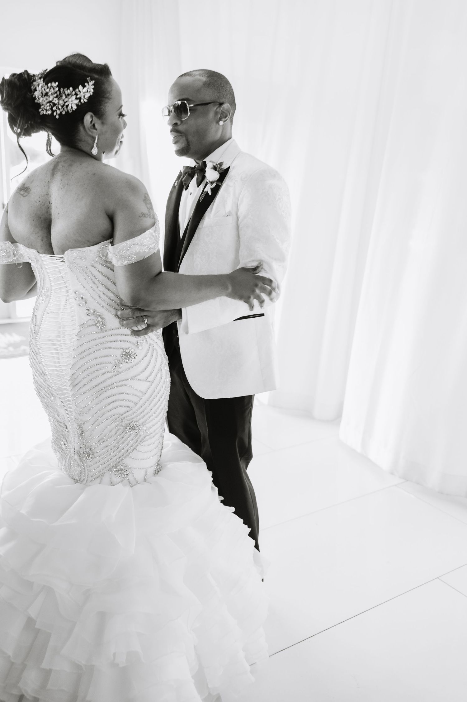 Candid wedding moments captured in black and white showing bride and groom dancing.