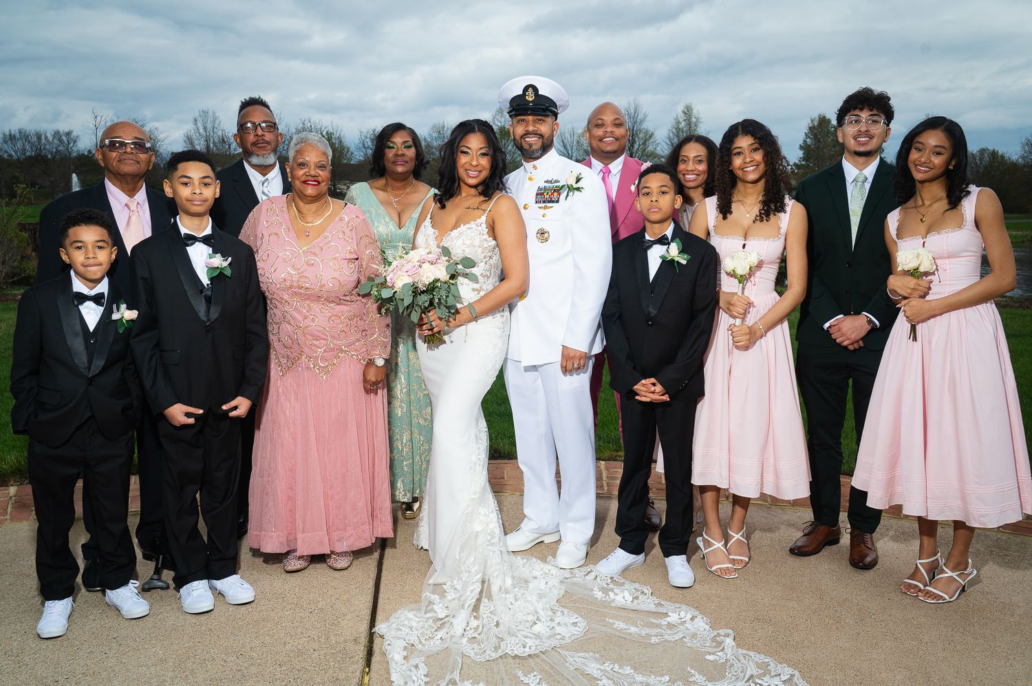 Wedding party group photos on grass with members in pink, white and formal attire.