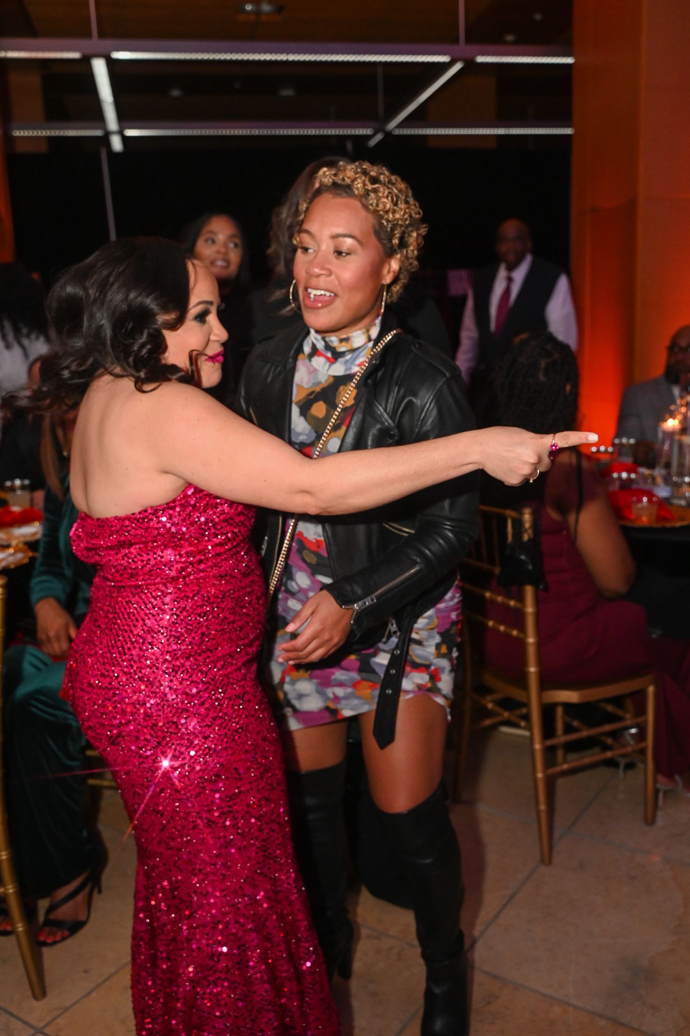 Celebratory dance moments captured at formal event with red decor.