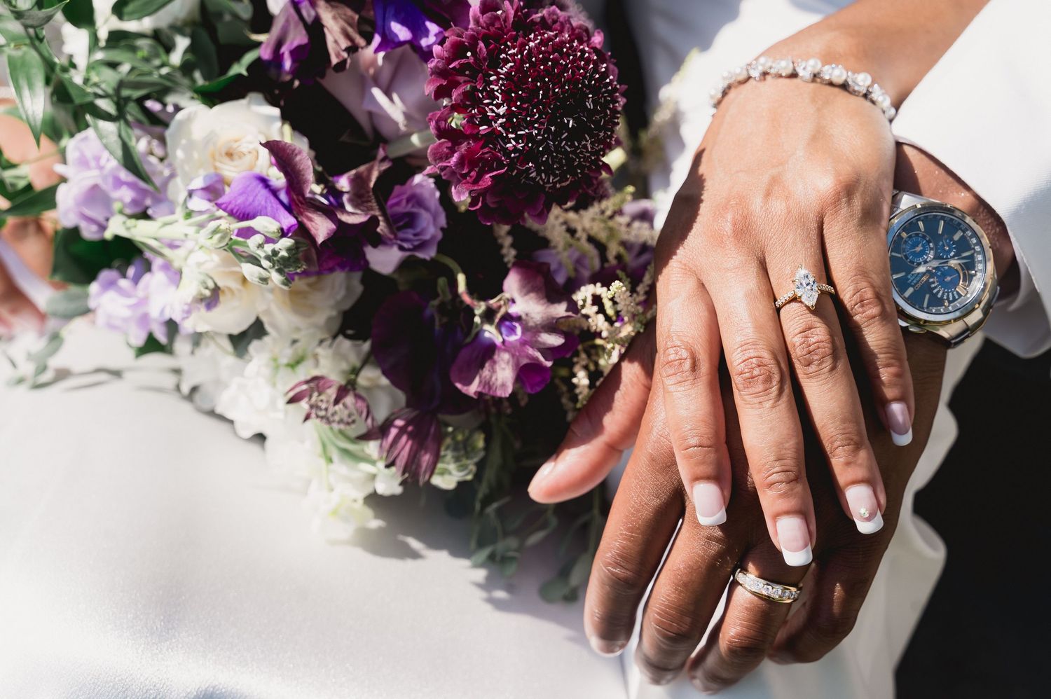 Close-up shots of hands with rings next to vibrant purple and pink floral arrangements.