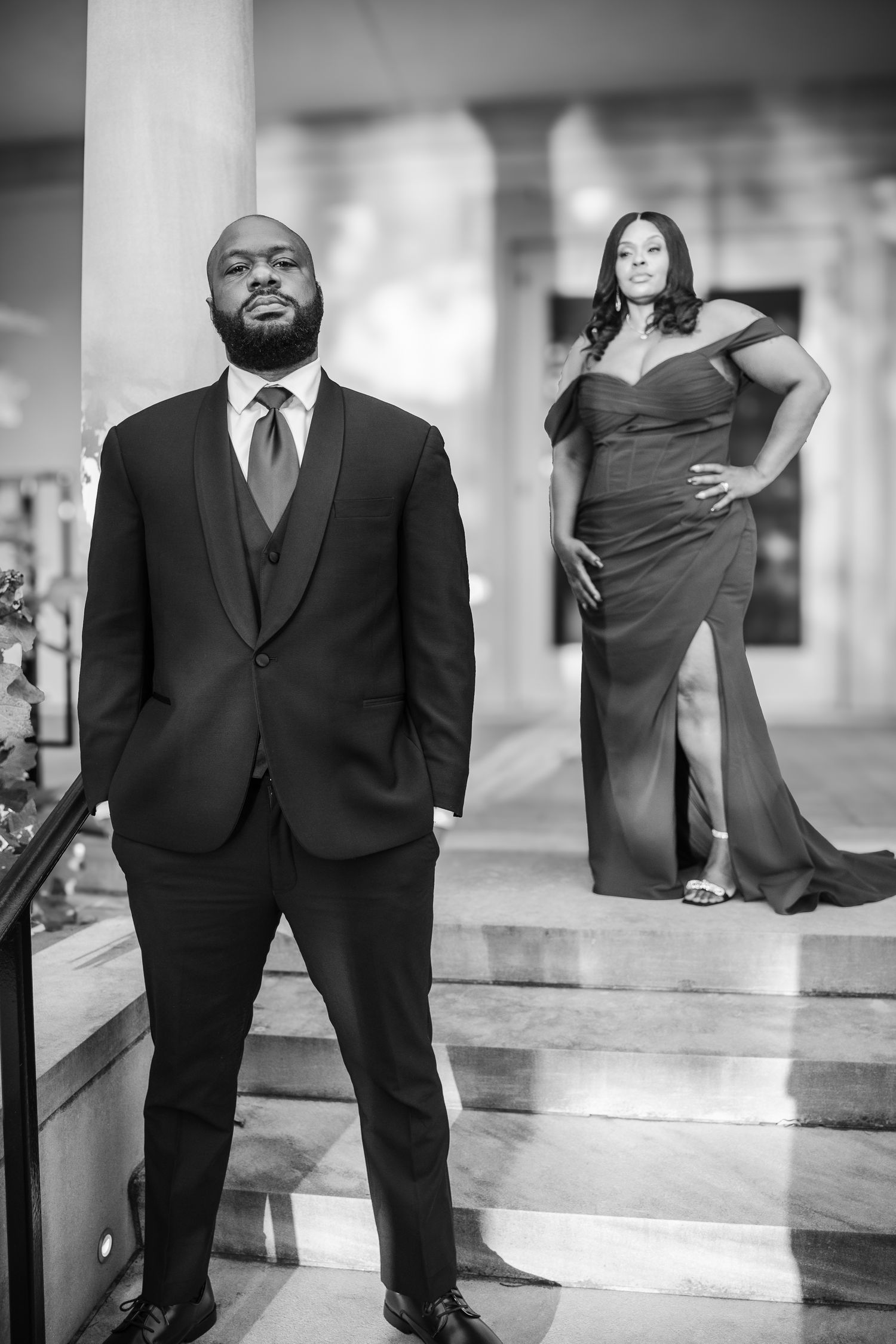 Black and white engagement photos on classic stone steps.