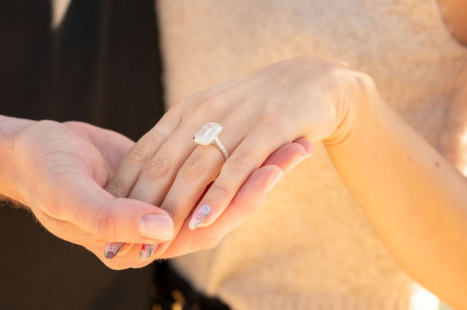 Sequence of hands joining together in warm sunset lighting.